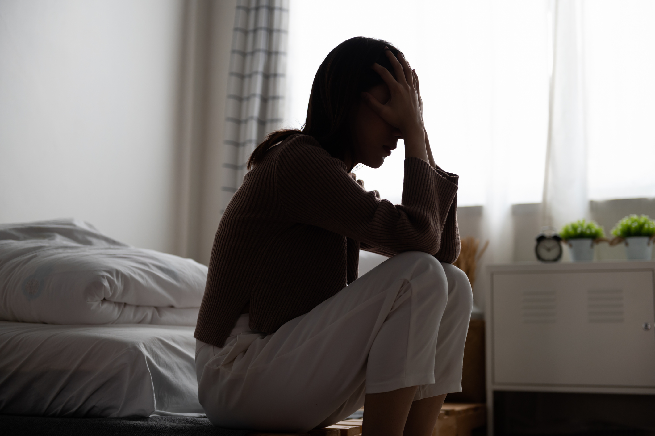 Close up young Asian woman feeling upset, sad, unhappy or disappoint crying lonely in her room. Woman health mental problem concept.