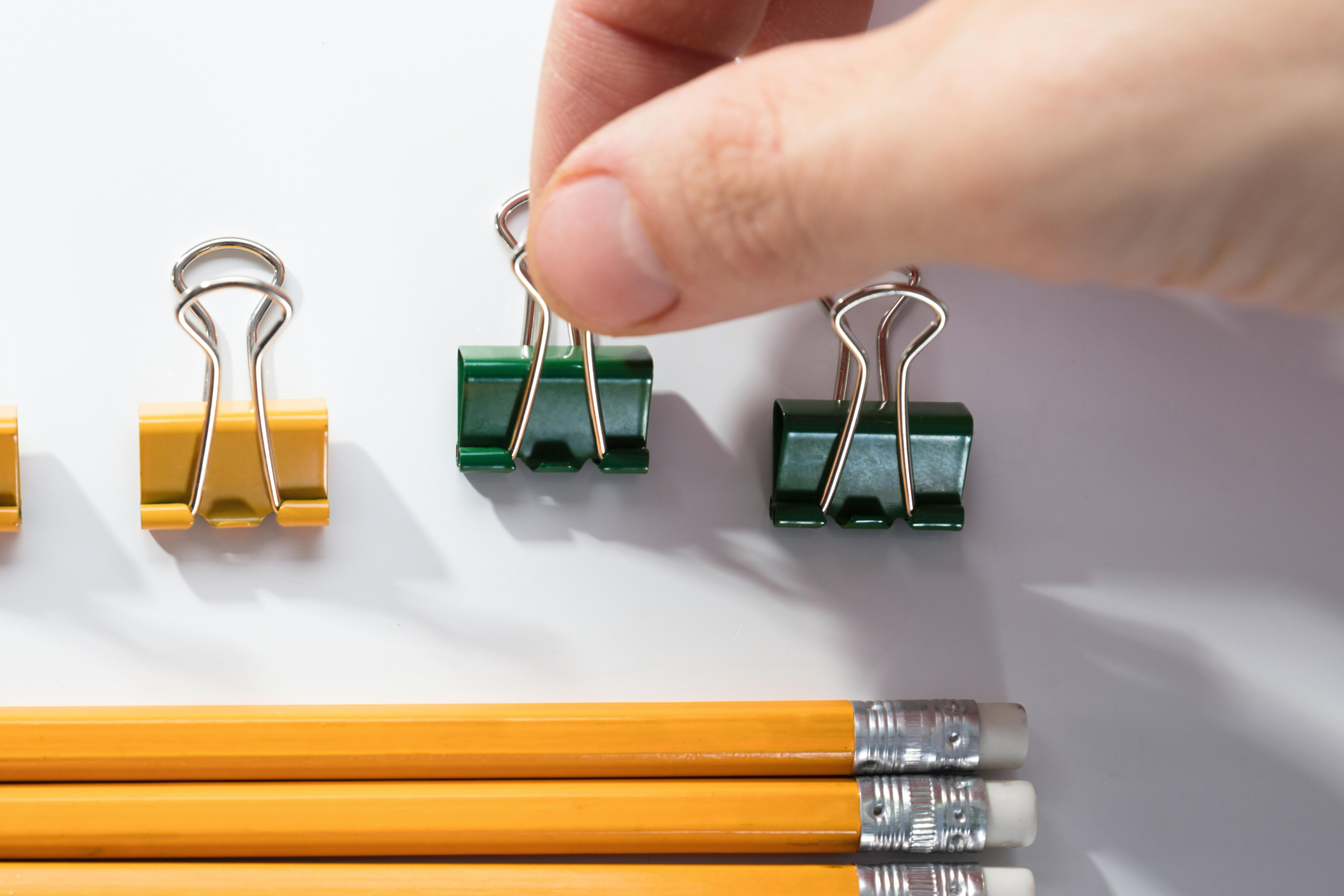 Person Arranging The Pencils On White Background