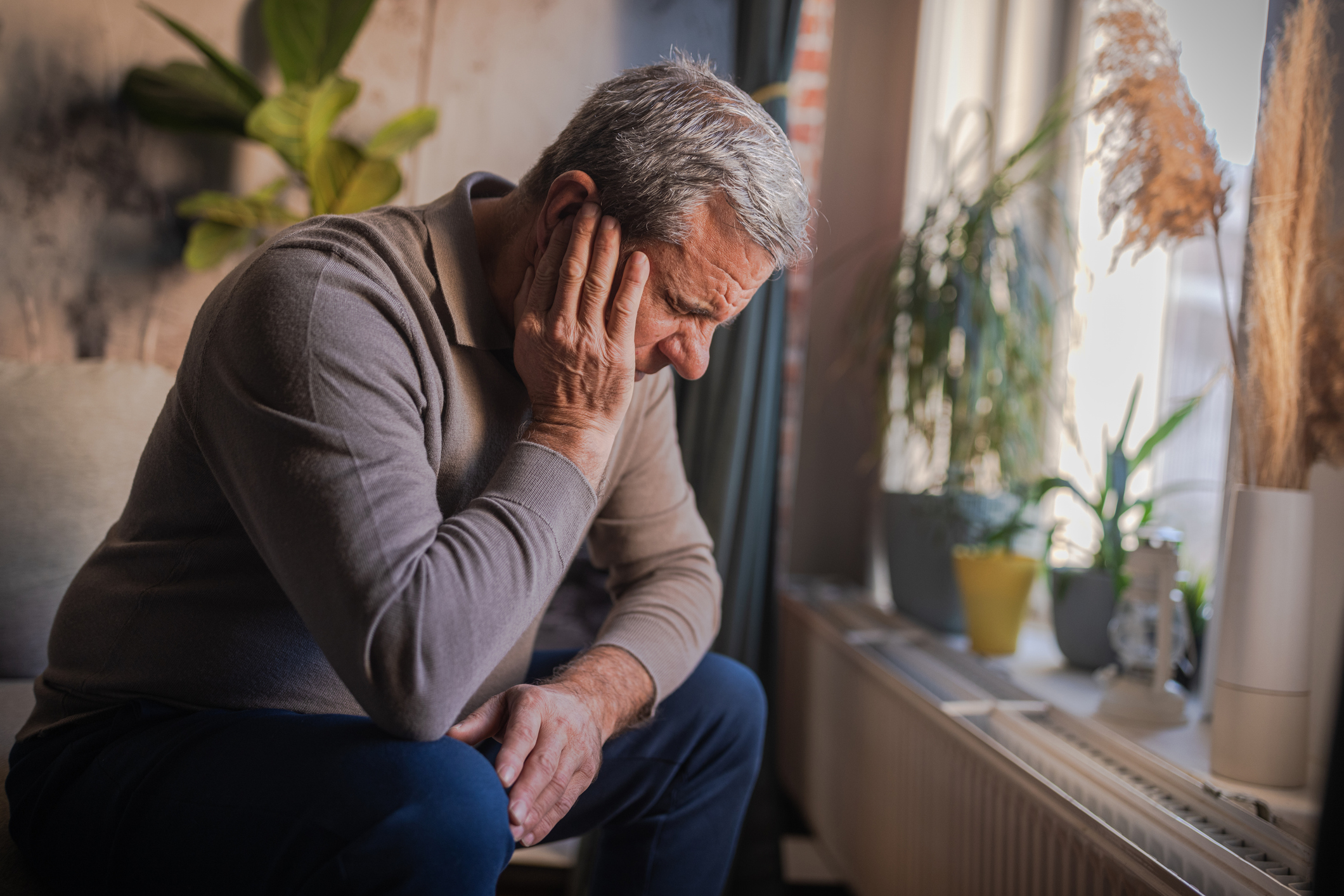 Stressed, unhappy man with severe earache