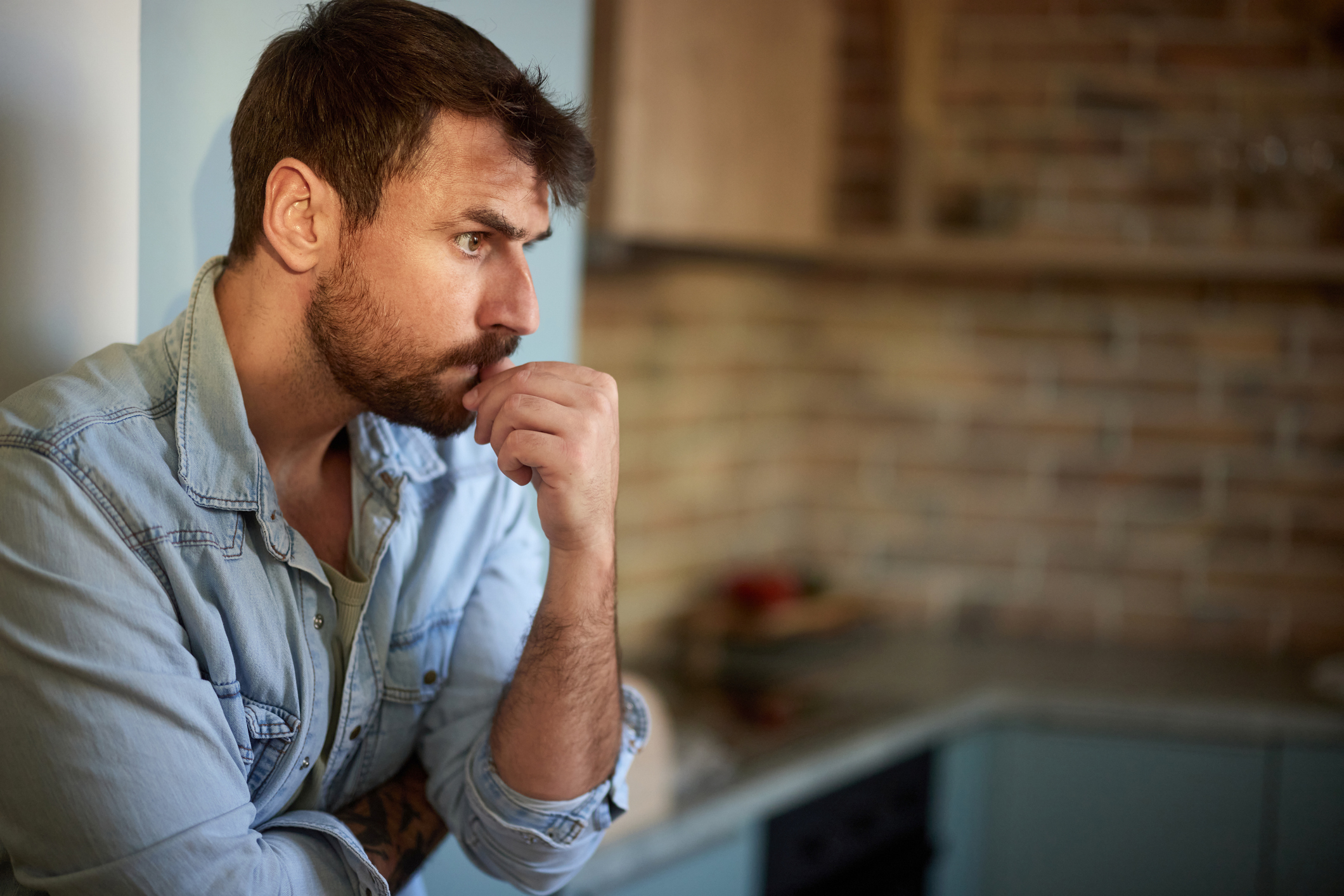 Worried man thinking of his problems at home.